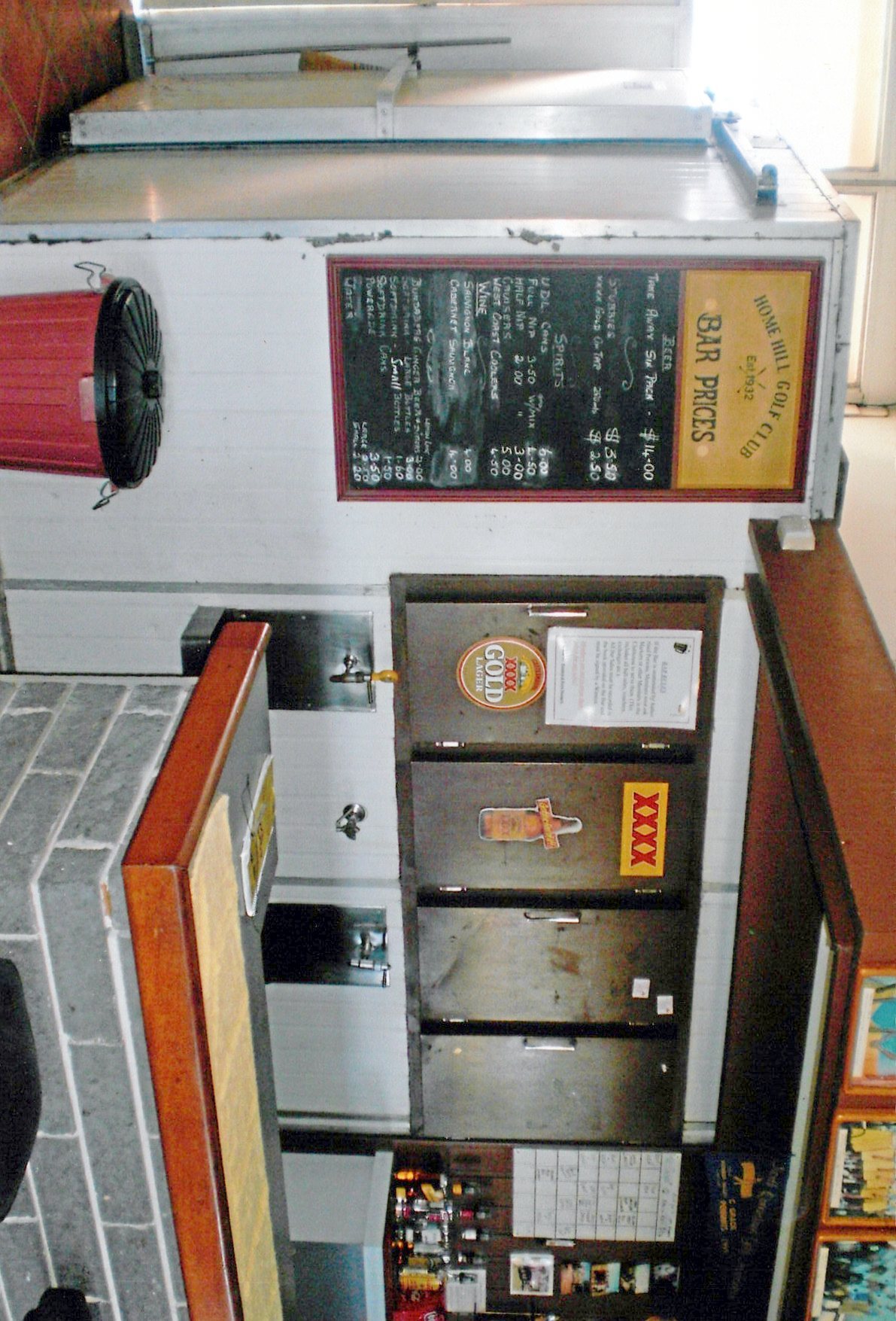 The clubhouse bar, beneath the 'Est. 1932' price board.